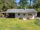 Well-maintained backyard with a pergola, a screened porch, a lush lawn, and lovely landscaping at 1307 Crabapple Ln, Raleigh, NC 27607