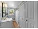 Charming bathroom features patterned wallpaper, white vanity, and ample natural light at 1307 Crabapple Ln, Raleigh, NC 27607