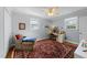Cozy bedroom features soft blue walls, two windows, and a charming desk area with a comfortable plaid chair at 1307 Crabapple Ln, Raleigh, NC 27607