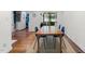 Cozy dining area features hardwood floors, a large table with blue chairs, and natural light at 1307 Crabapple Ln, Raleigh, NC 27607