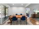 Bright dining room featuring hardwood floors and a large wooden table for gatherings at 1307 Crabapple Ln, Raleigh, NC 27607