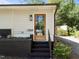 Charming front entrance featuring a glass paneled door, black brick accents, and landscaped garden area at 1307 Crabapple Ln, Raleigh, NC 27607
