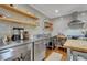 Functional kitchen boasting stainless steel appliances, open shelving, and hardwood floors at 1307 Crabapple Ln, Raleigh, NC 27607