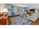 Bright living room featuring large windows, neutral furniture, and a colorful rug at 1307 Crabapple Ln, Raleigh, NC 27607
