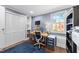Well-lit office featuring custom built-ins, an adjustable desk, and blue accent rug at 1307 Crabapple Ln, Raleigh, NC 27607