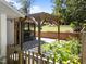 A wooden pergola graces a stone-paved patio, providing a serene view of the landscaped backyard at 1307 Crabapple Ln, Raleigh, NC 27607