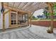 Backyard patio area features a wooden pergola, brick wall, and a covered porch at 1307 Crabapple Ln, Raleigh, NC 27607