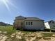 Home exterior featuring a back porch, grassy area and neutral-colored siding at 14 Cricket Hill Way, Benson, NC 27504