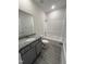 Well-lit bathroom featuring a granite-topped vanity, tile floor, and shower-tub combination at 14 Cricket Hill Way, Benson, NC 27504