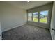 This bedroom features plush gray carpeting, neutral walls, and natural light from multiple windows at 14 Cricket Hill Way, Benson, NC 27504