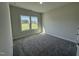 This bedroom features plush gray carpeting, neutral walls, and natural light from two windows at 14 Cricket Hill Way, Benson, NC 27504