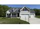 Charming two-story home featuring stone accents and a spacious three-car garage at 14 Cricket Hill Way, Benson, NC 27504