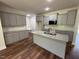Contemporary kitchen featuring gray cabinets, granite countertops, and a center island at 14 Cricket Hill Way, Benson, NC 27504
