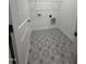 A bright laundry room featuring decorative tile flooring and a wire rack shelf at 14 Cricket Hill Way, Benson, NC 27504