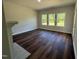 Spacious living room showcasing luxury vinyl flooring and natural light from large windows at 14 Cricket Hill Way, Benson, NC 27504