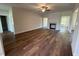Spacious living room with hardwood floors, a ceiling fan, and a cozy fireplace at 14 Cricket Hill Way, Benson, NC 27504