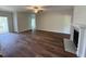 Large living room with hardwood floors, a ceiling fan, and a fireplace at 14 Cricket Hill Way, Benson, NC 27504
