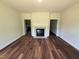Bright living room with luxury vinyl flooring featuring a traditional fireplace at 14 Cricket Hill Way, Benson, NC 27504