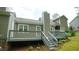 The home's backyard features a deck, neutral siding, a chimney, and easy access to the lush green yard at 1415 Quarter Pt, Raleigh, NC 27615