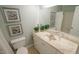 Bright bathroom features a single sink vanity with decorative accents and a shower-tub combo at 1415 Quarter Pt, Raleigh, NC 27615