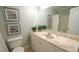 Bathroom with a single sink vanity, toilet, and framed wall art at 1415 Quarter Pt, Raleigh, NC 27615