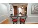 Stylish breakfast bar area with comfortable seating and view into the kitchen and dining room at 1415 Quarter Pt, Raleigh, NC 27615