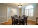 Bright dining room with hardwood floors, a dark wooden table set and a large arched window at 1415 Quarter Pt, Raleigh, NC 27615