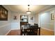 Dining room featuring hardwood floors, and views into the kitchen and hallway at 1415 Quarter Pt, Raleigh, NC 27615