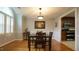 Traditional dining room with hardwood floors, square table, and a view into the kitchen at 1415 Quarter Pt, Raleigh, NC 27615