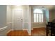 Bright entryway featuring hardwood floors, a window with shutters, and neutral wall colors at 1415 Quarter Pt, Raleigh, NC 27615
