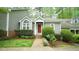 Charming home featuring a bright red front door, brick walkway, and well-maintained landscaping at 1415 Quarter Pt, Raleigh, NC 27615