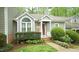 Inviting home entrance with a red front door and attractive landscaping at 1415 Quarter Pt, Raleigh, NC 27615
