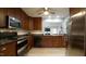 Well-equipped kitchen with stainless steel appliances, dark countertops, and a tiled floor at 1415 Quarter Pt, Raleigh, NC 27615