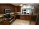 A well-lit kitchen with granite countertops and stainless steel appliances at 1415 Quarter Pt, Raleigh, NC 27615