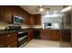 Modern kitchen featuring stainless steel appliances, granite countertops, and ample cabinet space at 1415 Quarter Pt, Raleigh, NC 27615