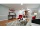 A stylish living room with a grey rug, sofa, a decorative table and a red chair at 1415 Quarter Pt, Raleigh, NC 27615