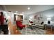 Inviting living room with hardwood floors, grey rug and comfortable seating arrangement at 1415 Quarter Pt, Raleigh, NC 27615
