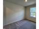 Bedroom featuring neutral-colored walls, carpet, and a bright window at 152 Parker Ln, Mebane, NC 27302