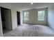 Large bedroom with natural light and spacious closet with neutral colored carpet at 152 Parker Ln, Mebane, NC 27302