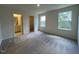 Spacious bedroom features natural light from two windows and neutral carpet flooring at 152 Parker Ln, Mebane, NC 27302