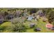 Areal view of home surrounded by lush green trees and buildings at 1556 Pleasants Rd, Wendell, NC 27591
