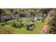 Aerial view of the charming house nestled among beautiful, mature trees at 1556 Pleasants Rd, Wendell, NC 27591
