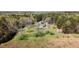 Aerial view of home with sheds and lush vegetation at 1556 Pleasants Rd, Wendell, NC 27591