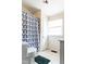 Clean bathroom featuring a toilet, shower with curtain, and a window at 1556 Pleasants Rd, Wendell, NC 27591