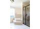 Bright bathroom featuring a soaking tub, a tiled shower, and large windows at 1556 Pleasants Rd, Wendell, NC 27591