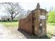 Property entrance featuring a stone column, '1556' address number, and a pineapple finial on top at 1556 Pleasants Rd, Wendell, NC 27591