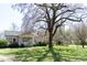 Exterior shot of the front of a single-story home with mature trees at 1556 Pleasants Rd, Wendell, NC 27591