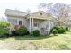 Charming single-story home with a columned front porch and mature landscaping at 1556 Pleasants Rd, Wendell, NC 27591