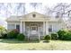 Charming single-story home with a columned front porch, dormer, and mature landscaping at 1556 Pleasants Rd, Wendell, NC 27591