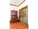Charming hallway featuring wood floors, a hutch and a glass paneled door at 1556 Pleasants Rd, Wendell, NC 27591